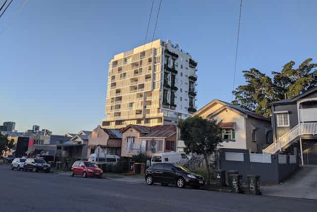 Houses and a high-rise block in a residential street