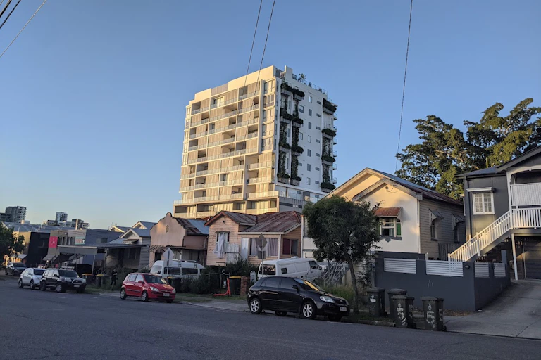 Houses and a high-rise block in a residential street