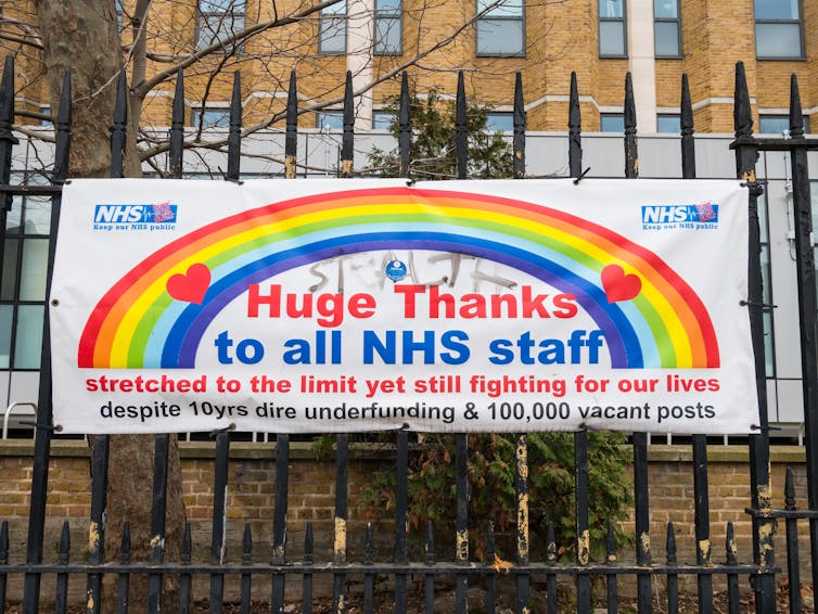 Sign on railings supporting NHS staff during strike.