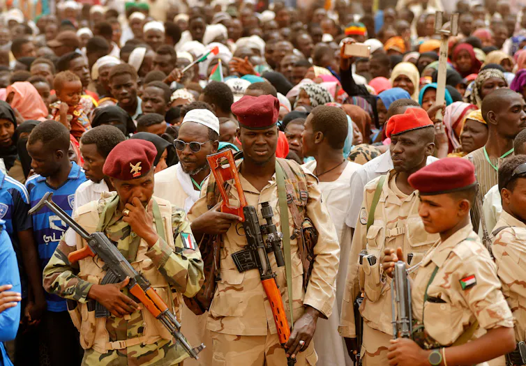 Sudanese soldiers from the Rapid Support Forces unit with a crowd of people in Khartoum, Sudan, June 2019