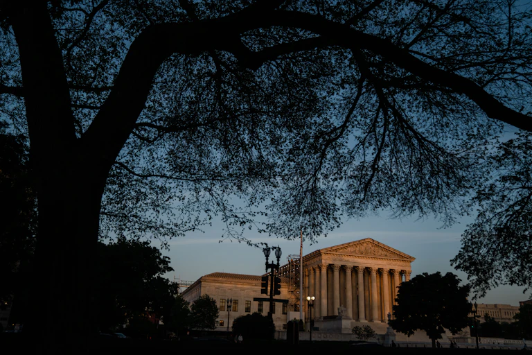 The U.S. Supreme Court building at dusk.