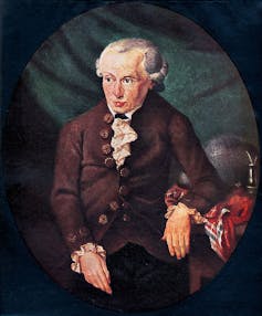 A centuries-old painting of a serious-looking seated man in a powdered wig and brown suit.