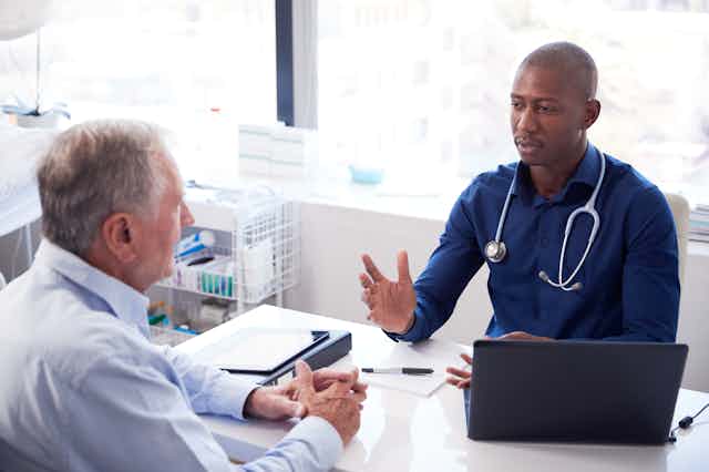 GP consulting with patient