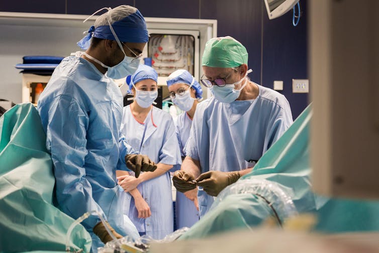 Medical students in the operating room observing a professor