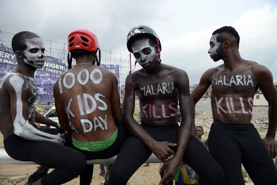 Actors paint their bodies with paint to draw attention to the deaths caused by malaria