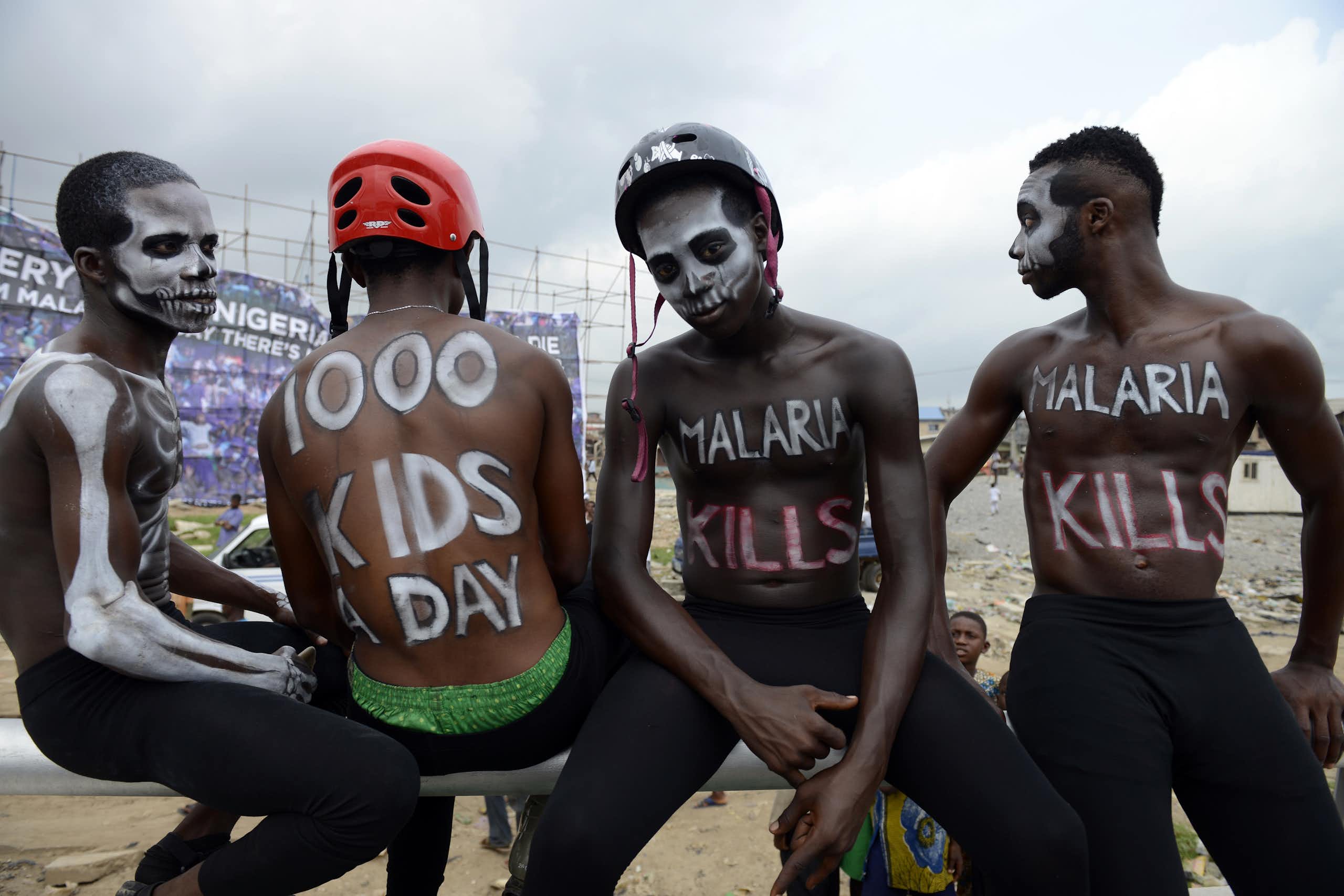 Actors paint their bodies with paint to draw attention to the deaths caused by malaria