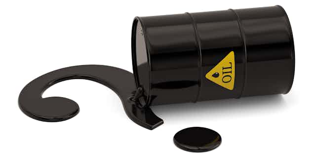 A black barrel on its side leaking out oil into the shape of a question mark.