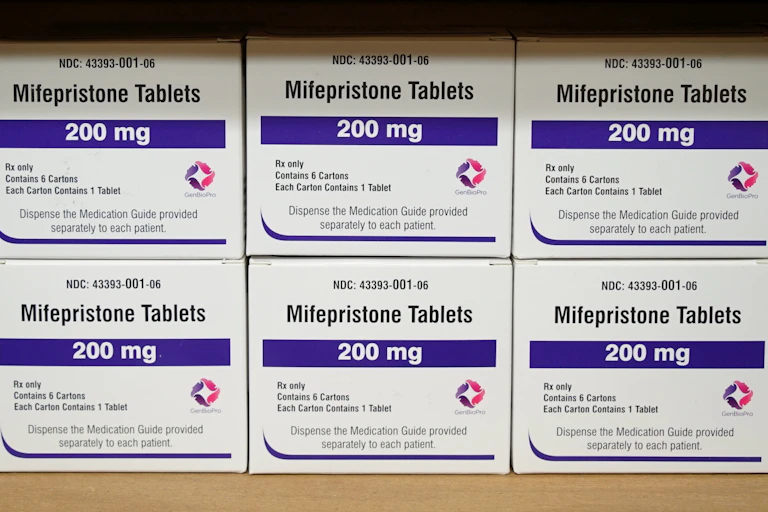 Six boxes of mifepristone tables sitting on a shelf, displaying 200 milligram labels.
