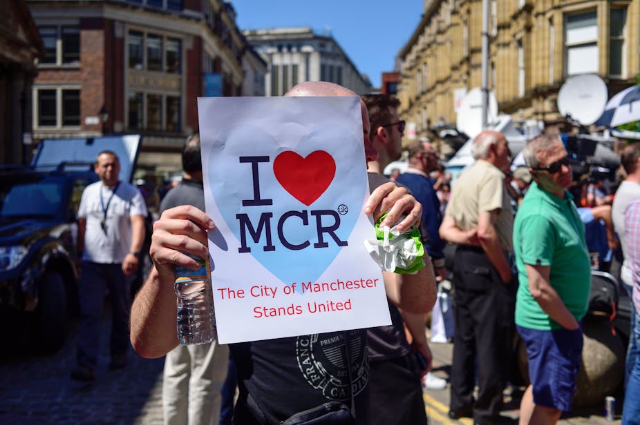 Man holds up I love Manchester sign