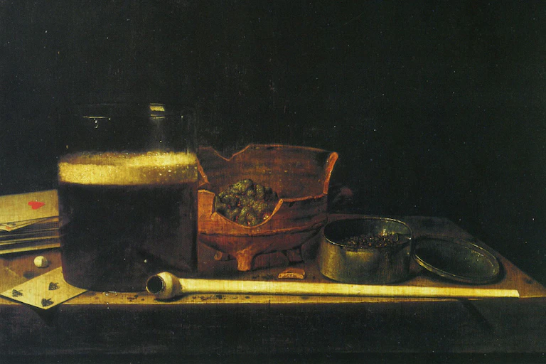 A still life with cards, beer and a clay pipe.