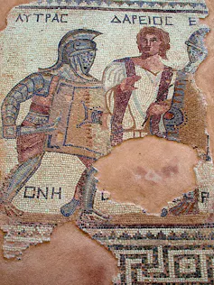 A Roman mosaic showing a gladiator in a silver shiny helmet.