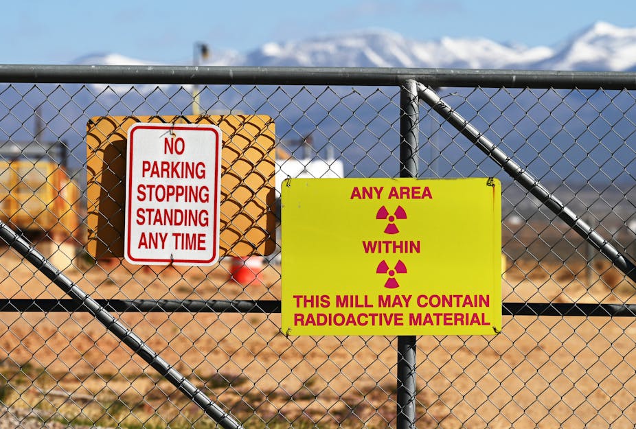 A gate with warning signs about the presence of radioactive materials