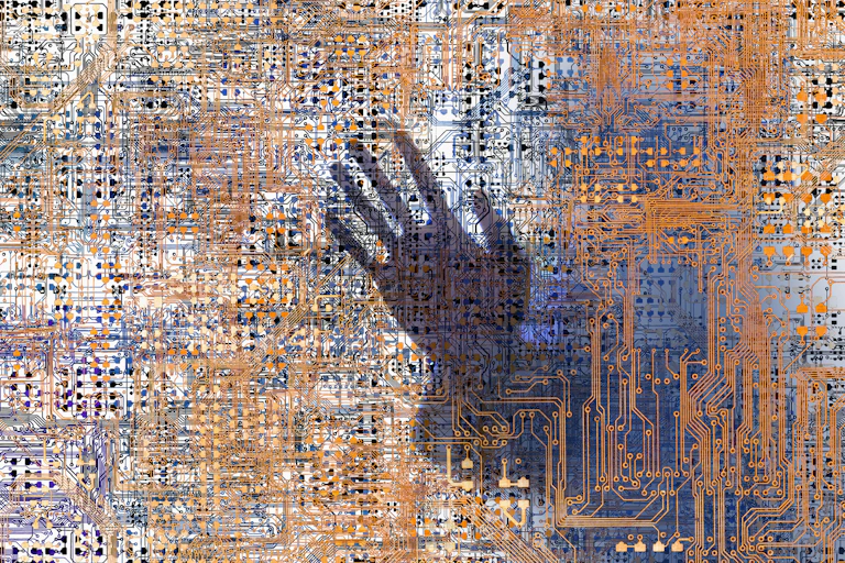 The outline of a human hand trapped behind a grid of tiny intersecting circuits.