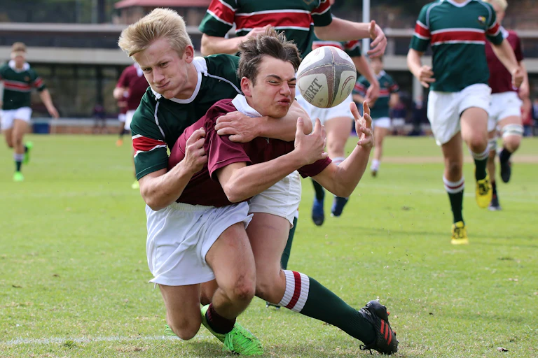 Young men colliding while playing football