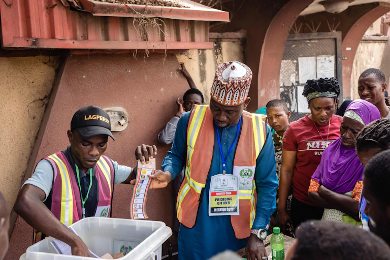 Two men holding a ballot paper