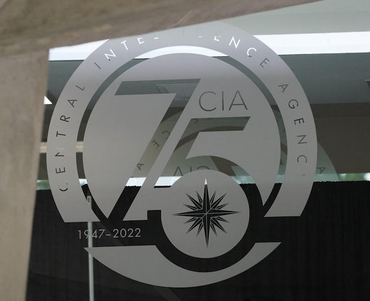 The logo of the CIA on a glass door.