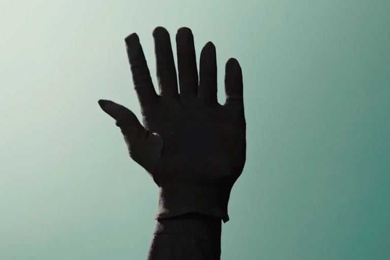 The picture of a glove containing a sixth, robotic finger