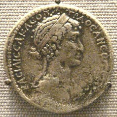 A silver coin showing Cleopatra's face.