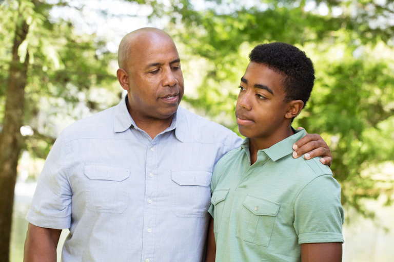 Father and son talking outside