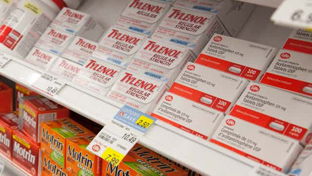 A pharmacy shelf displaying acetaminophen products