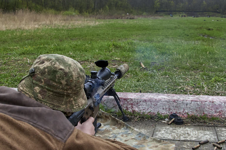A Ukrainian soldier firing a machine gun during training.