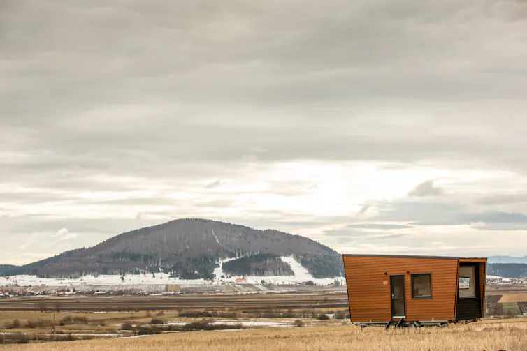 A wide shot of a small house in a big landscape.