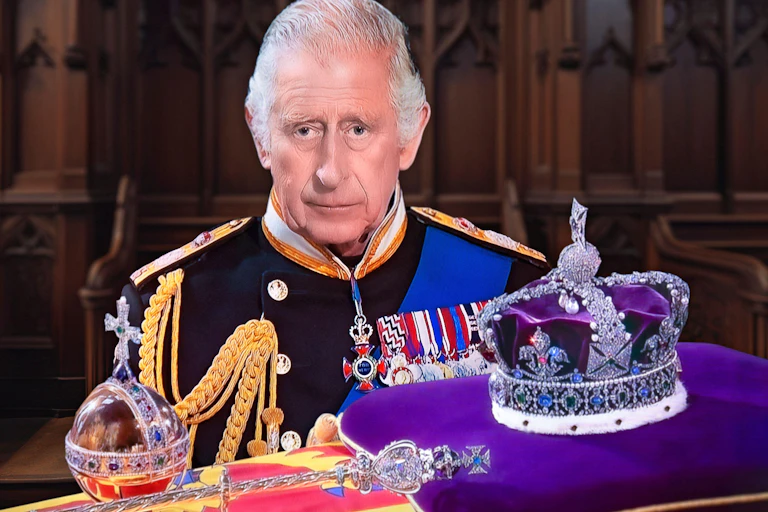 King Charles III in military dress, stands behind the imperial state crown, sceptre and orb