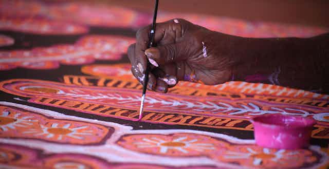 An artist with Warlukurlangu Artists, an Indigenous-owned art centre in the Northern Territory.