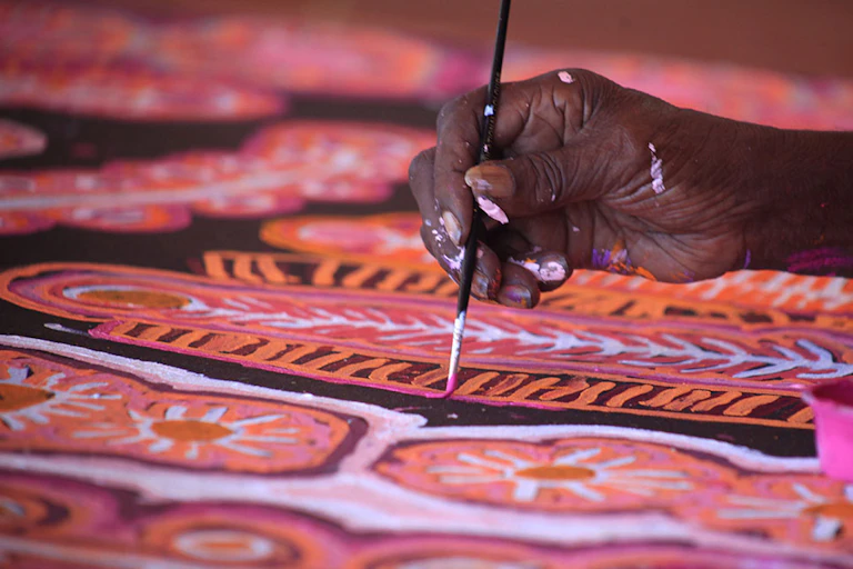 An artist with Warlukurlangu Artists, an Indigenous-owned art centre in the Northern Territory.