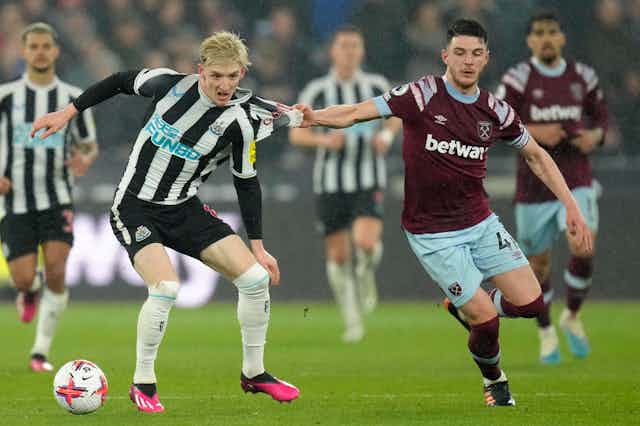 Newcastle's Anthony Gordon being challenged by West Ham's Declan Rice