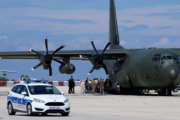 A large aircraft on the runway in Cyprus, having flown in from Sudan.