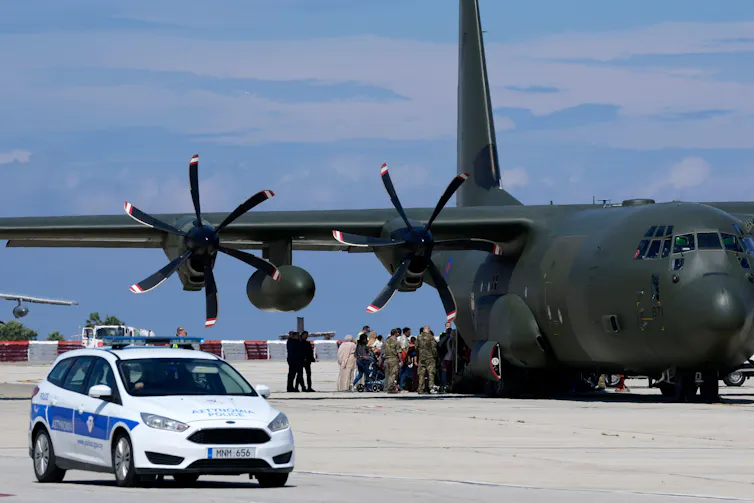 A large aircraft on the runway in Cyprus, having flown in from Sudan.