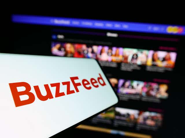 Buzzfeed logo against a computer screen