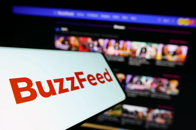 Buzzfeed logo against a computer screen