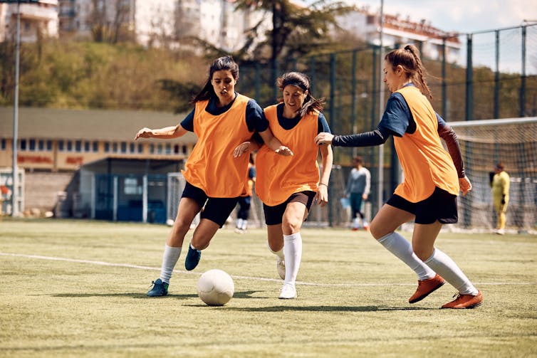 Female soccer players training on the field