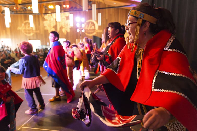 Indigenous women perform at a powpow.