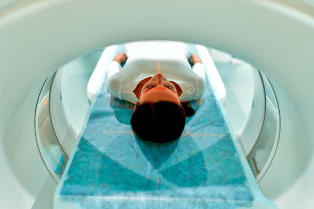Woman lying in an MRI scanner.