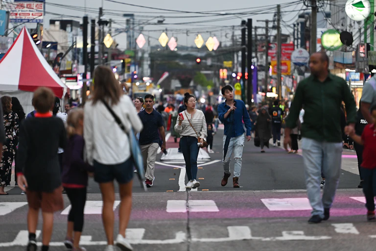 picture of men and women walking on a street