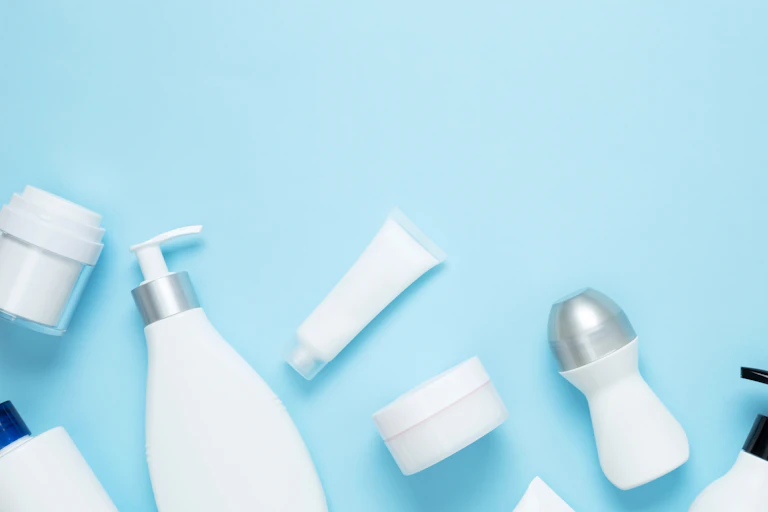white beauty product containers on a blue background