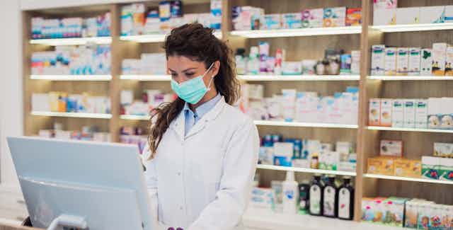 Pharmacist types on a computer