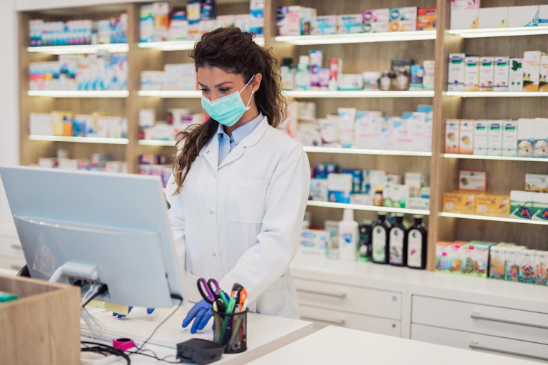 Pharmacist types on a computer