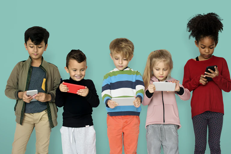 Children seen holding tech devices.