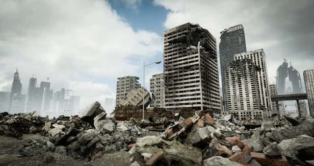 A computer-generated illustration of a destroyed city, including collapsing high-rises in the background and mounds of rubble in the foreground.