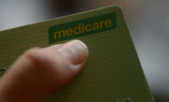 Hand holds Medicare card