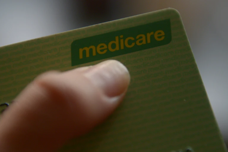 Hand holds Medicare card