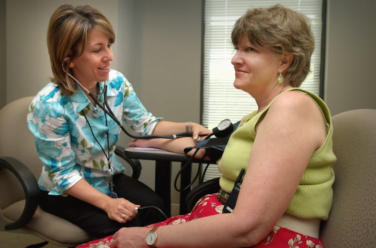 Doctor takes her patient's blood pressure