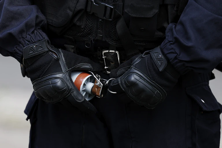 Un policier s'apprête à utiliser une grenade de désencerclement lors d'affrontements avec des manifestants à Lille le 1er mai. Les violences de la part de certains policiers font l'objet d'enquêtes de l'IGPN dont le rôle est très critiqué par la société civile.