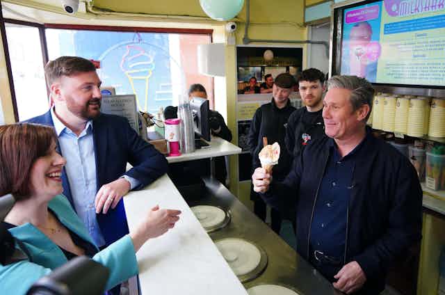 Keir Starmer serving an ice cream to his colleagues at an ice cream parlour. 