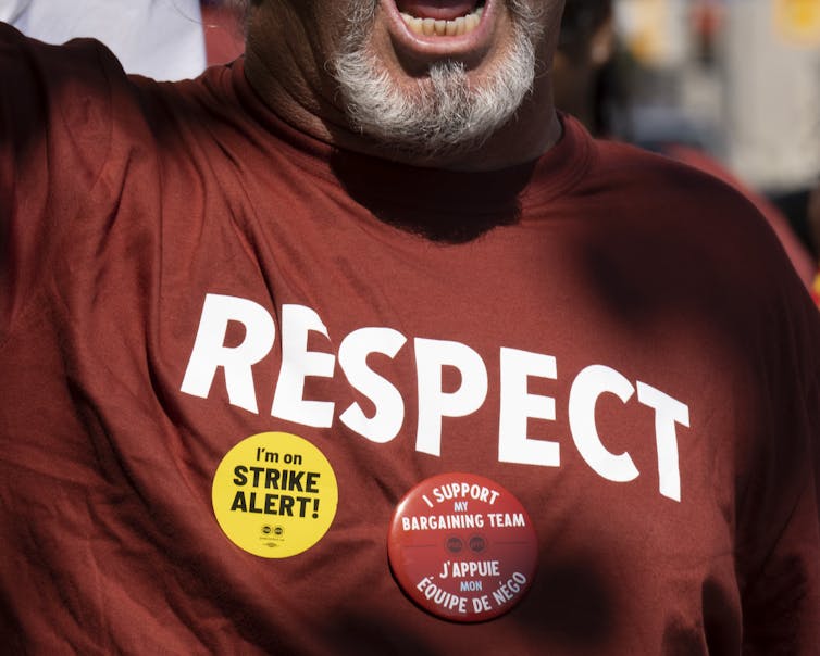 A man shouts while wearing a hoodie that reads Respect