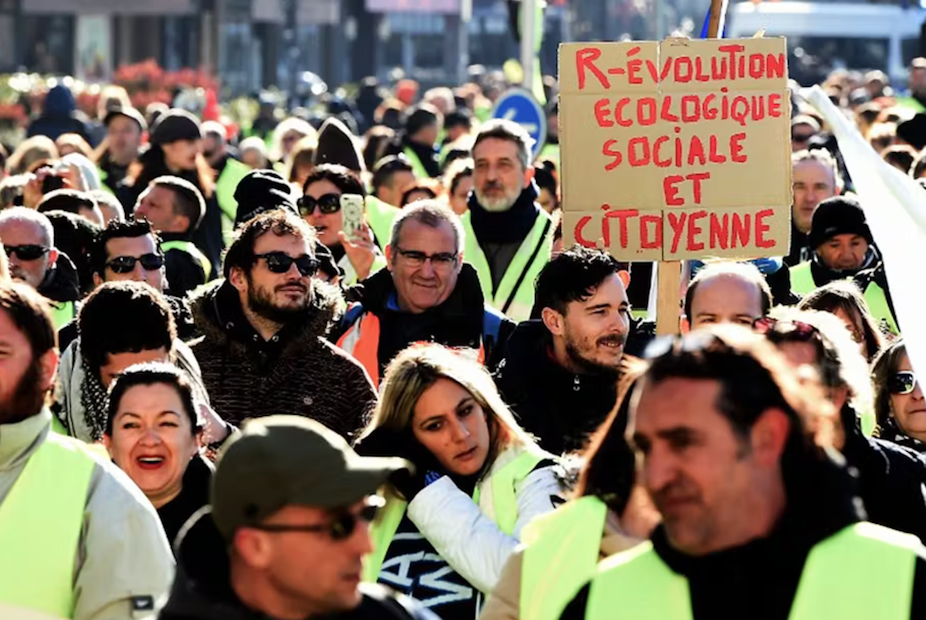 foule de gilets jaunes avec une pancarte révolution écologique sociale et citoyenne